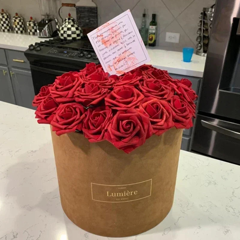 A bouquet of deep red artificial foam roses in a brown paper container with a handwritten tag.