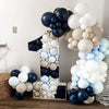 A large number one balloon arrangement featuring assorted latex balloons in shades of white, gray, and navy blue.