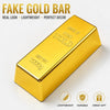 Barra de oro brillante rectangular de plástico, etiquetada como Oro Fino 999.9, sobre fondo blanco.