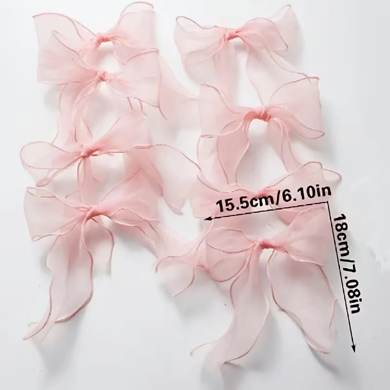 Pink tulle bow garland for party decor featuring sheer pink fabric bows.