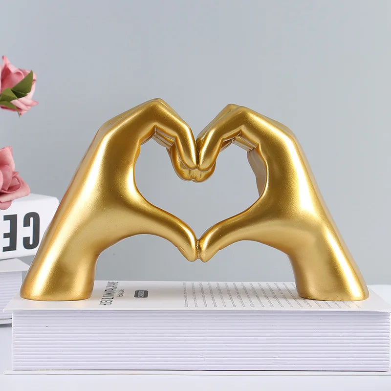A golden heart shape sculpture made of resin, designed for desk or shelf display.