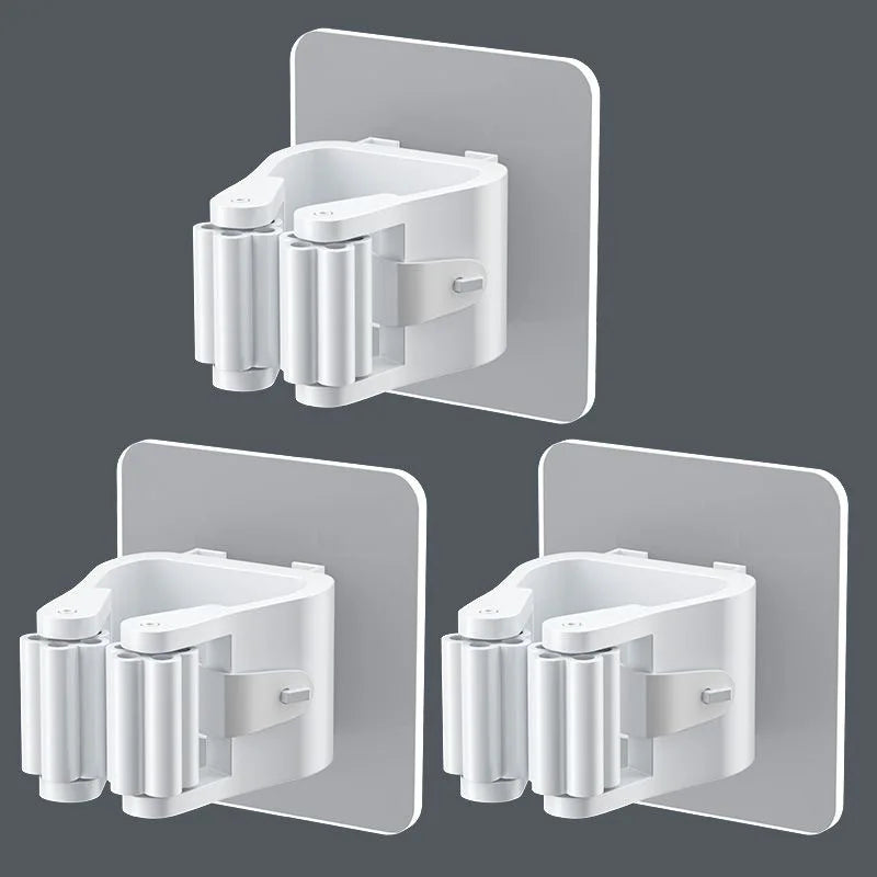 A white adhesive wall hook designed to hold mops and brushes, shown in various angles against a gray background.