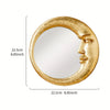 A round, gold resin decorative hanging mirror featuring a stylized face profile.