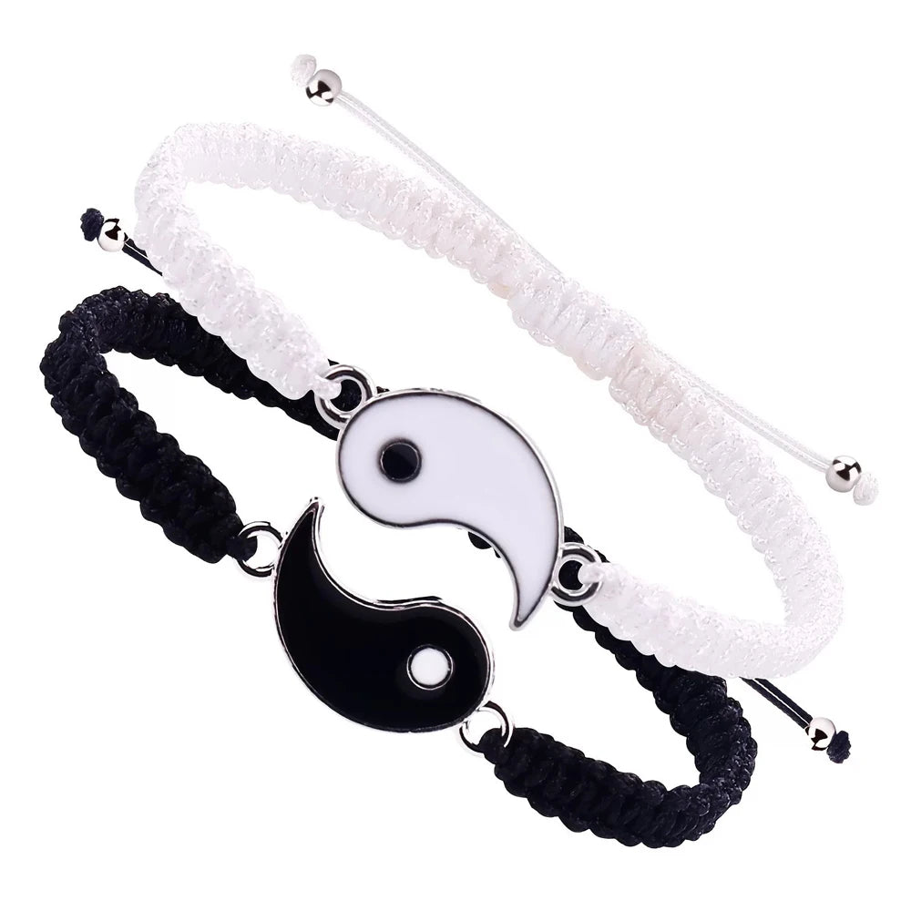 A set of braided white and black Tai Chi Yin-Yang bracelets for wrist wear.