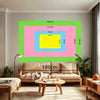A modern living room setup featuring a large framed print with vibrant colors and a beige sofa.