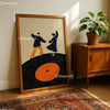 A framed canvas art print depicting two figures holding hands against a black vinyl record background.