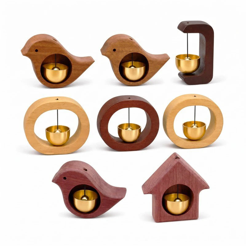 A collection of wooden wind chimes shaped like bird or house doorbells, featuring brass bells inside.