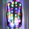 A person wearing an LED light-up neon costume jacket and pants set, illuminated with various bright colors.