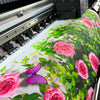 A close-up of a festive Christmas door banner featuring pink and green floral designs.