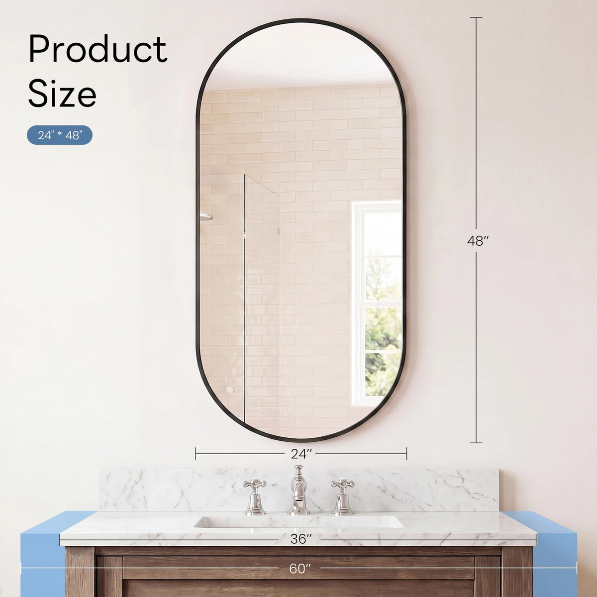 A round oval mirror with a black metal frame hanging above a marble vanity countertop.