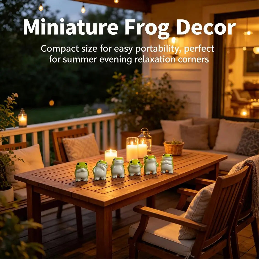 A set of six cute resin frog figurines displayed on a wooden table in an outdoor relaxation setting.