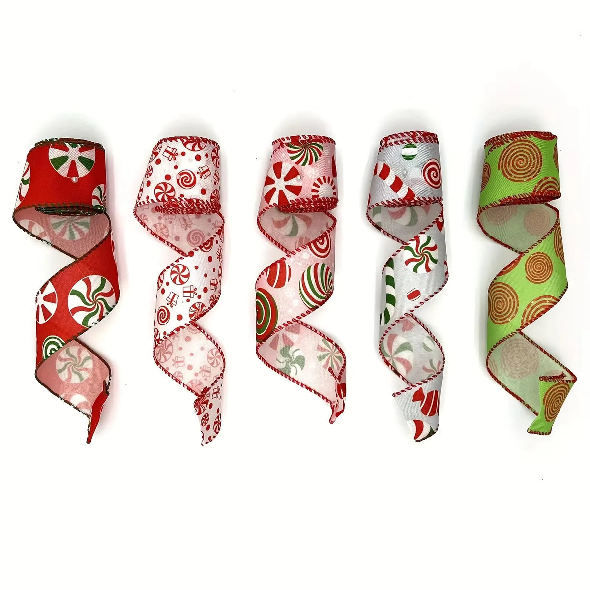A collection of red and green candy cane patterned burlap ribbons rolled into spirals.