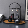 A black leather and wrought iron desk organizer rack holding two black pens.