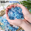 Hands hold crushed blue acrylic pebbles used as quality material for decorative purposes.