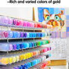 A close-up view of a set of 36 color acrylic paint markers in various shades of gold and other colors, displayed in plastic c