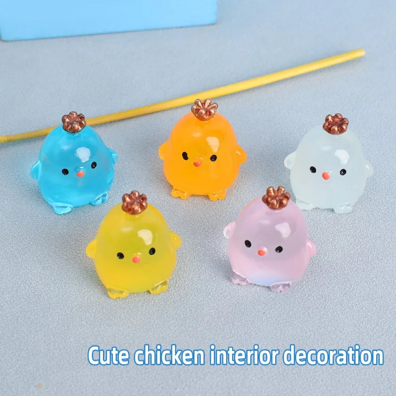 A collection of colorful luminous resin chicken car ornaments in shades of blue, orange, yellow, and pink.
