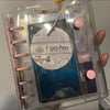 A clear binder holds a pink macaron binder with a Harry Potter themed card and other collectibles.
