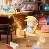 A collectible figurine of a pony with light blue accents sits on a wooden surface next to a glass bottle.