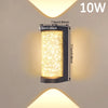 A rectangular LED crystal outdoor wall sconce with a warm yellow light, mounted on a wall.
