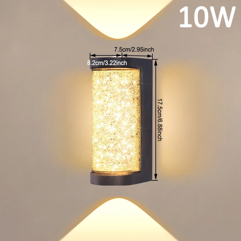 A rectangular LED crystal outdoor wall sconce with a warm yellow light, mounted on a wall.