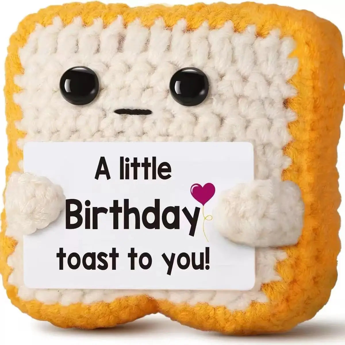 A handmade crochet baseball bat doll with a smiling face and a birthday toast card.