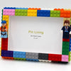 A colorful building block photo frame kit featuring a white frame and various colored plastic blocks.
