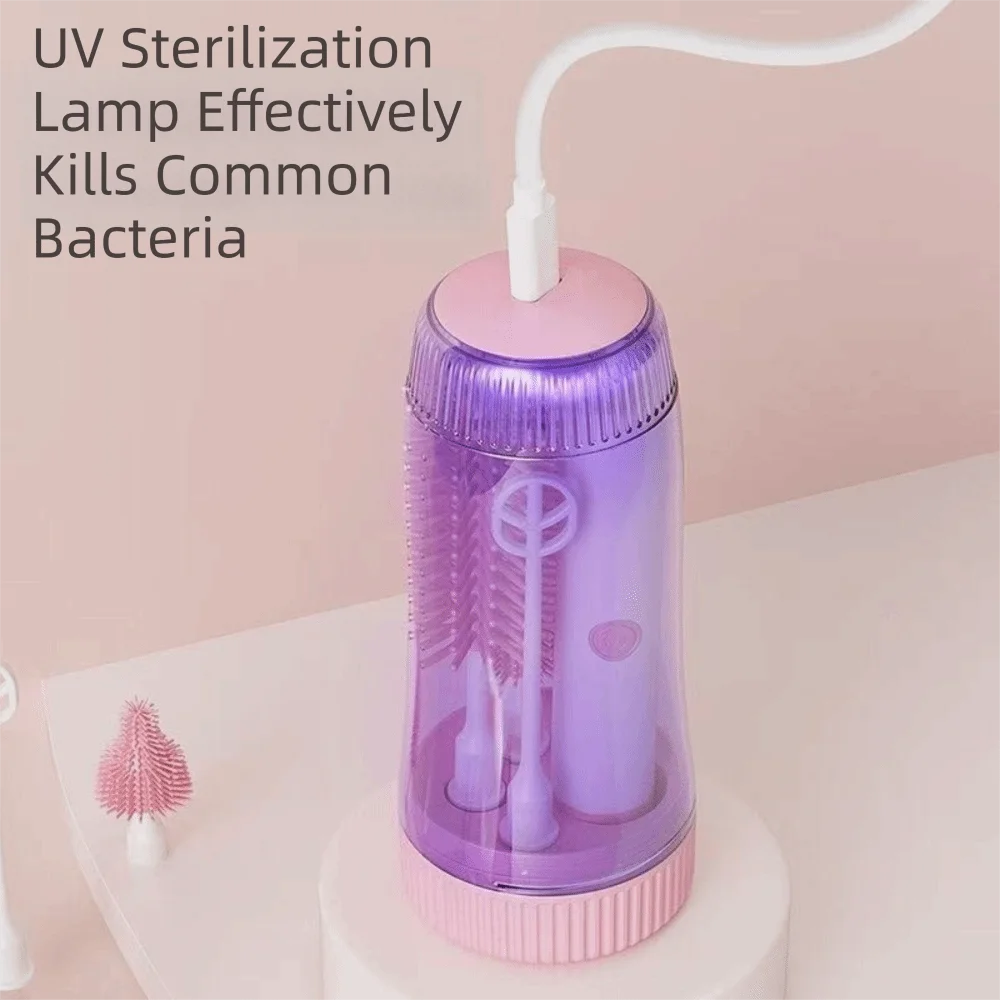 A purple electric baby bottle cleaning brush with a white handle and storage case is shown on a white surface.
