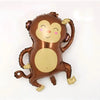 A brown, plush animal decoration resembling a monkey or jungle creature with light tan accents.