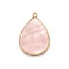 A teardrop-shaped pink agate and rose quartz pendant charm with a gold-colored bail.