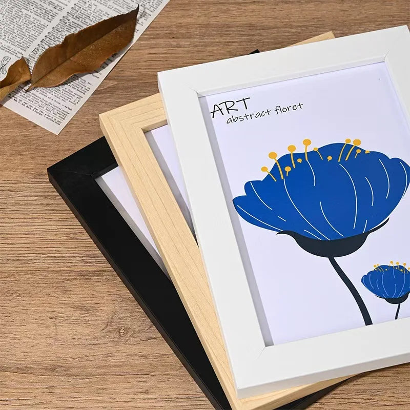 A white wooden photo frame displaying an abstract blue flower illustration titled ART abstract floret.