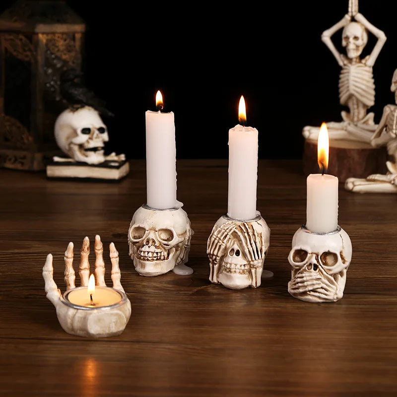 A row of five white pillar candles in skull-shaped holders on a wooden surface.