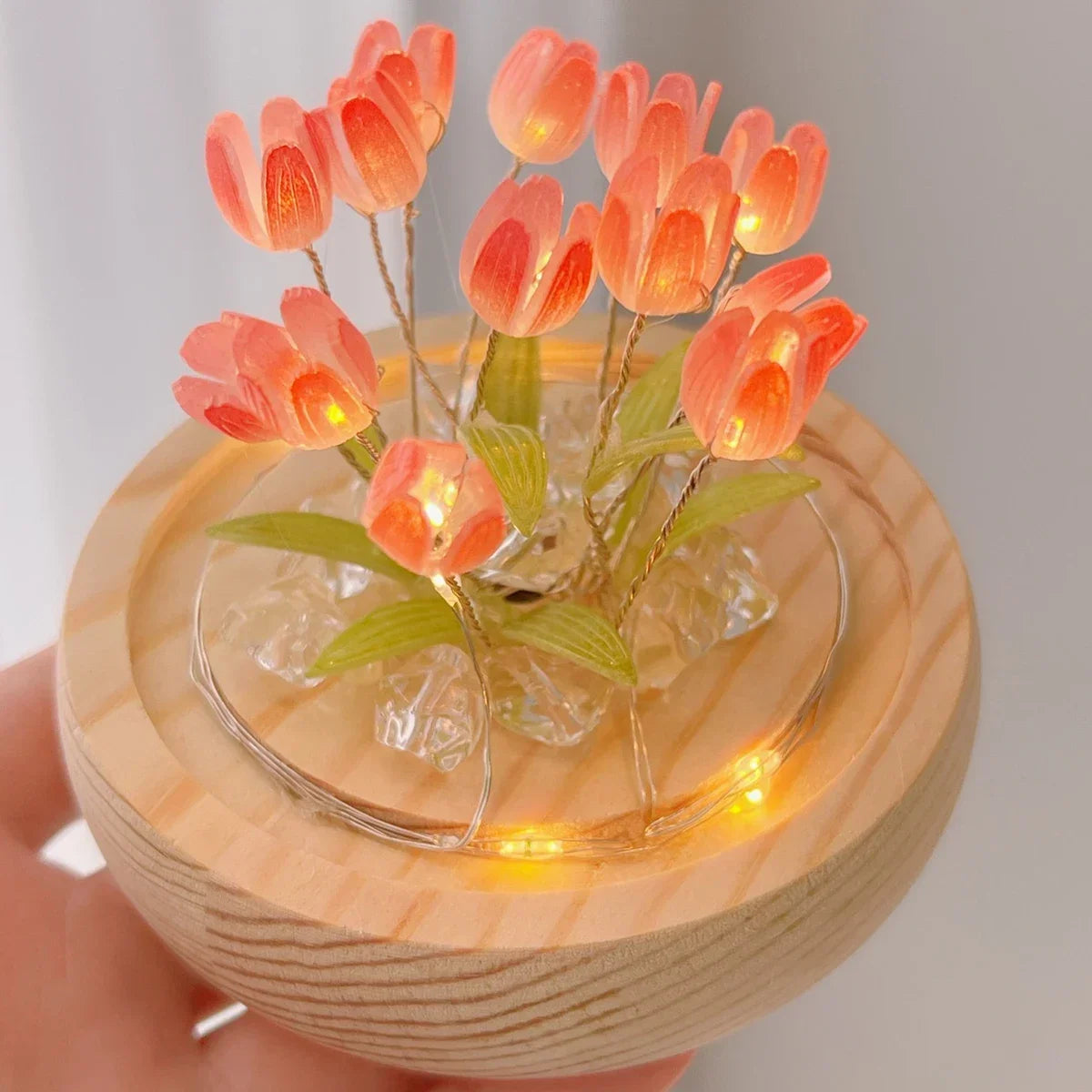Handmade LED tulip night light featuring orange-pink flowers on a wooden base