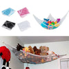 A mesh storage organizer hammock filled with colorful stuffed animals hanging in a room.