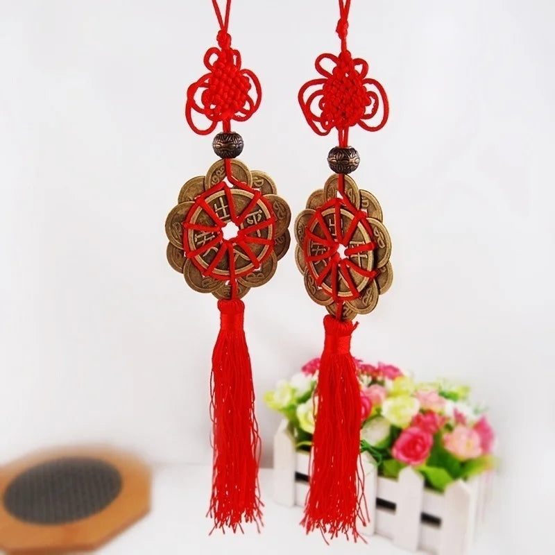 Red and gold mystic knot wall decor featuring tassels and circular designs