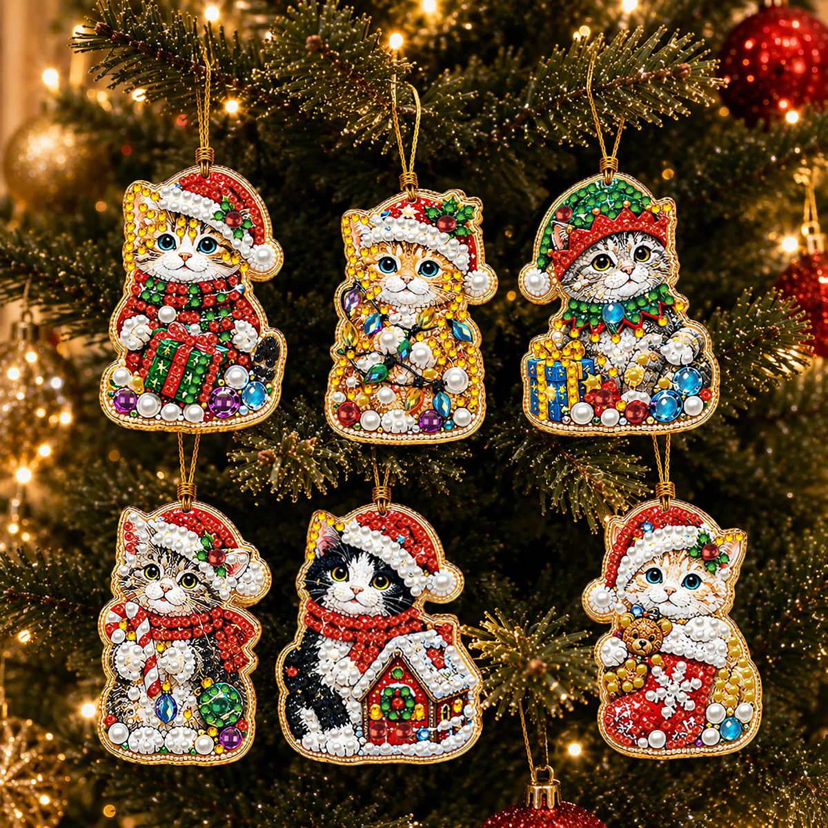 A set of Christmas diamond art ornaments featuring cats in Santa, snowman, and reindeer designs hanging on a green tree.