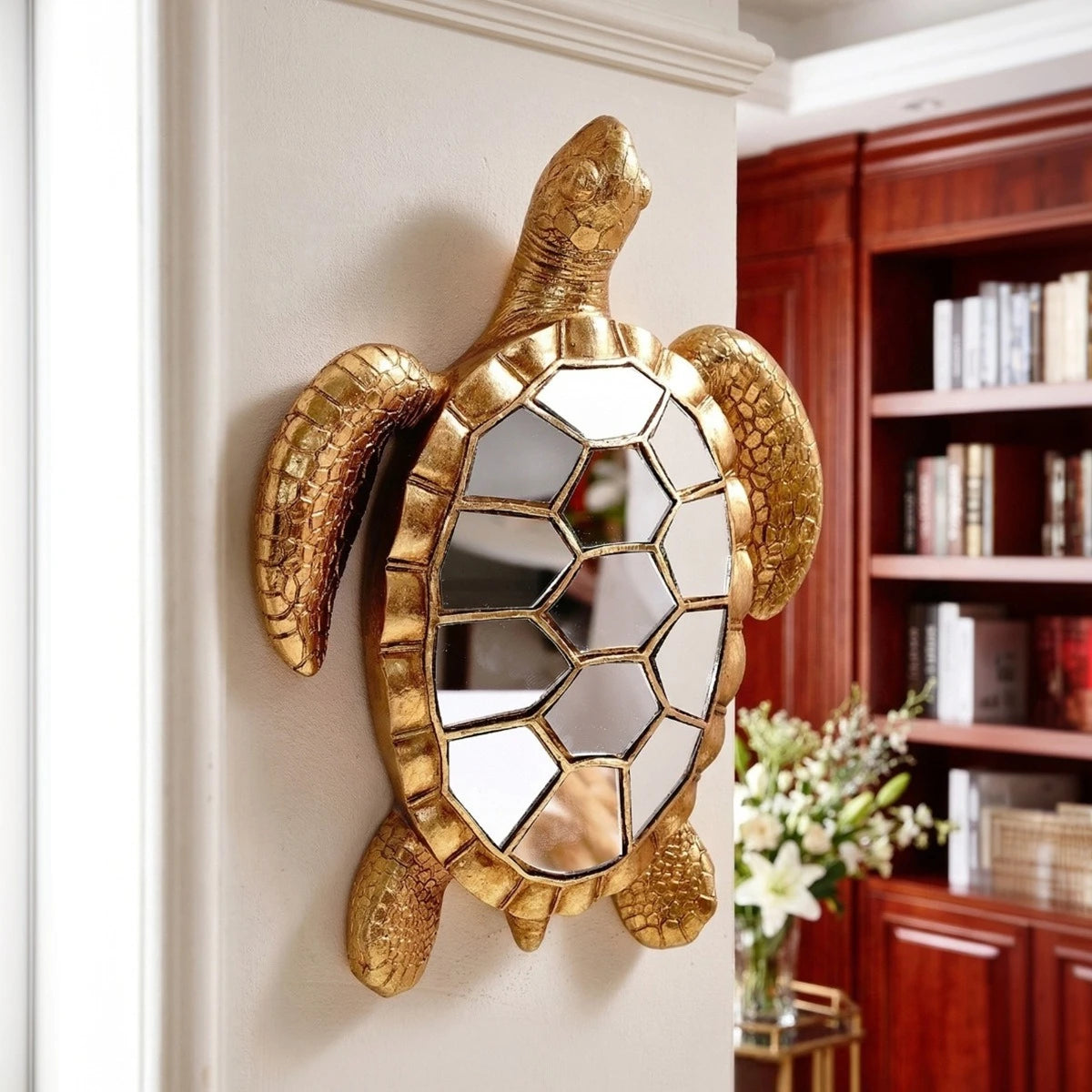 Golden sea turtle resin wall decor mirror mounted on a white wall