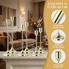 A set of polished brass metal taper candle holders displayed on a marble surface in a living room setting.