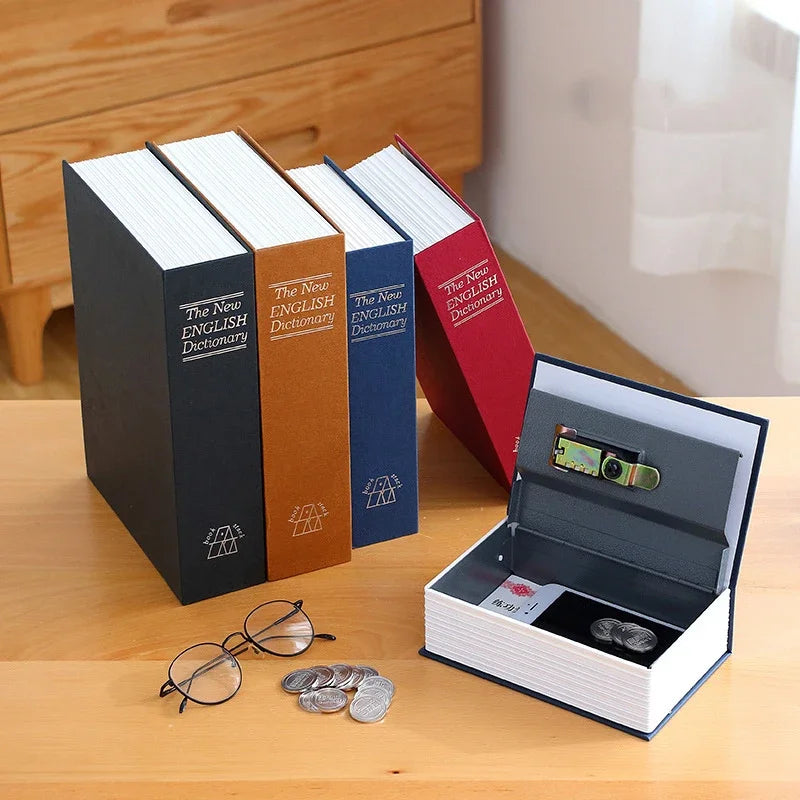 A set of three hardcover English dictionaries and a small box with a combination lock resting on a wooden surface.