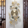 A decorative wall clock featuring a metal ginkgo leaf design with gold accents and a round face.