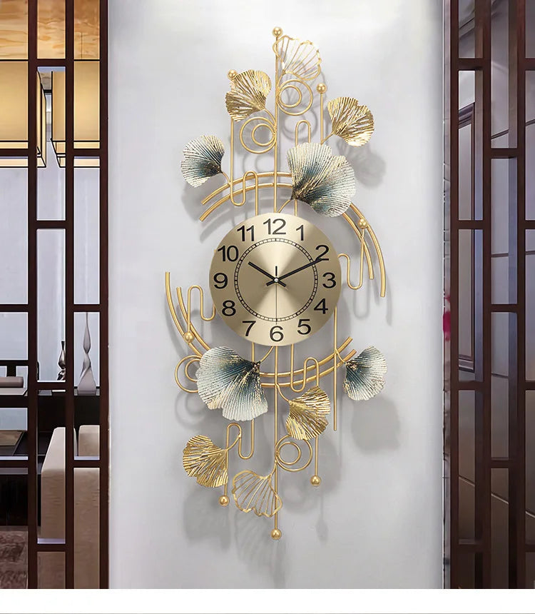 A decorative wall clock featuring a metal ginkgo leaf design with gold accents and a round face.