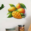 A decorative wall sticker featuring an orange mango fruit and green leaves.
