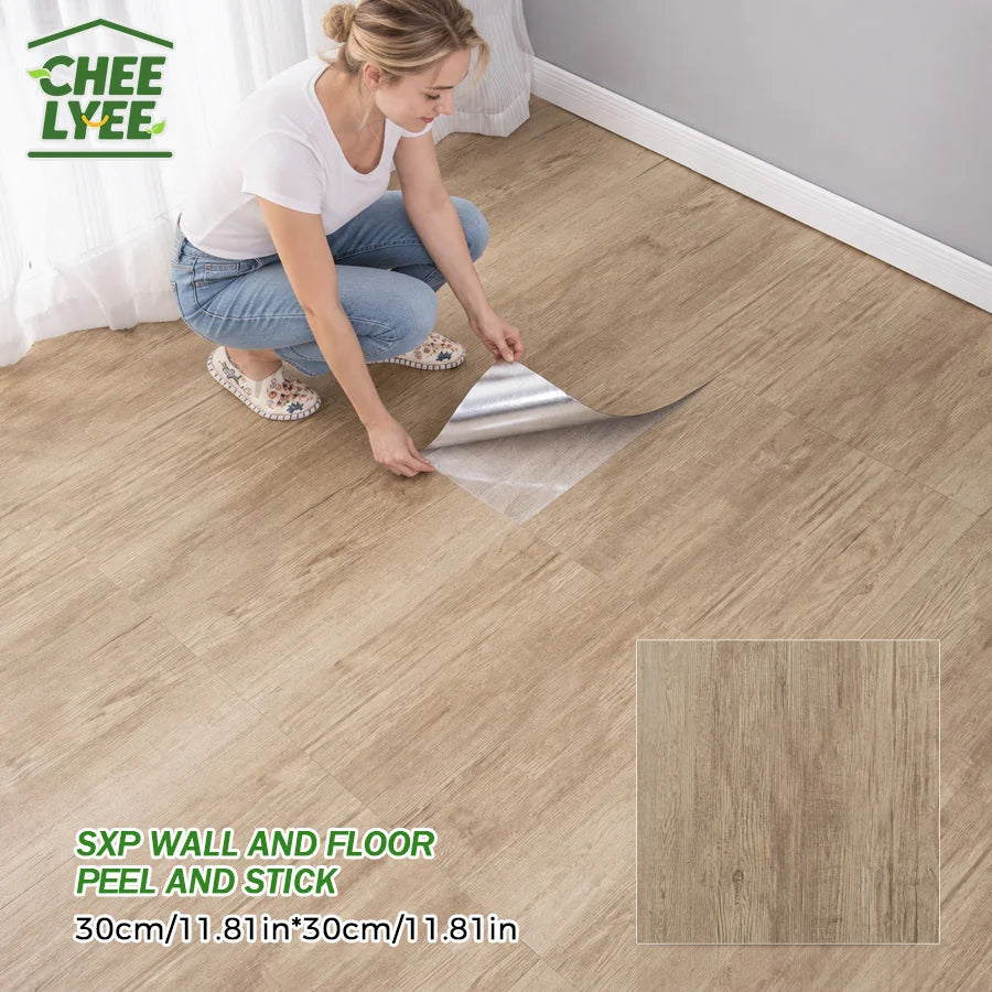 A woman is applying peel and stick wood grain wall tiles to a floor, demonstrating the installation process.