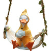 Handmade resin climbing monkey figurine in yellow and white hanging from a vine.