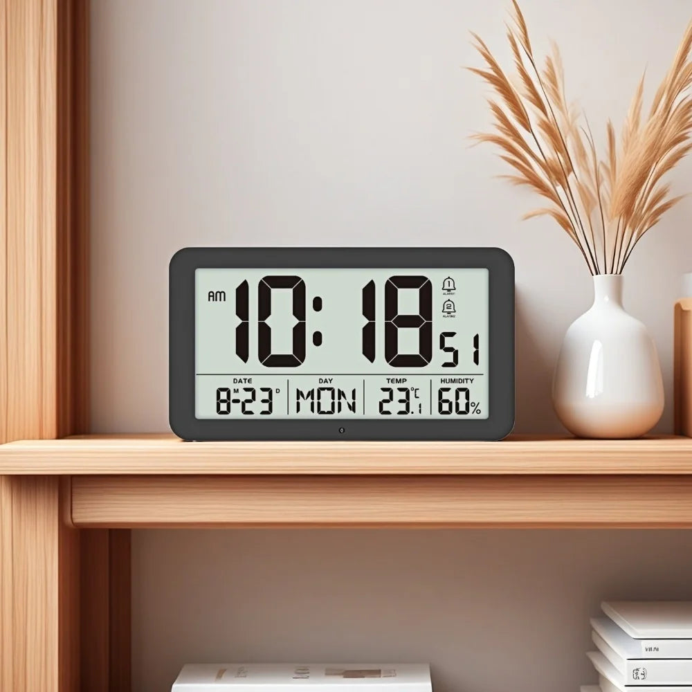A black digital wall clock displaying the time 10:18 AM, date, temperature, and humidity on a wooden shelf.