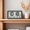 A black digital wall clock displaying the time 10:18 AM, temperature 23 degrees, and humidity 60 percent.