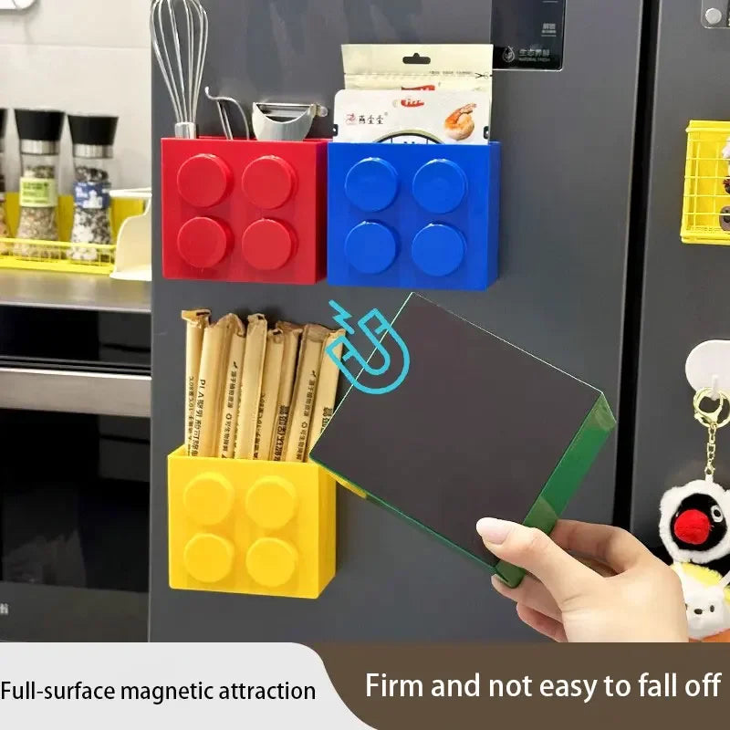 A hand holds a green magnetic storage rack attached to a dark cabinet, showing firm surface magnetic attraction.