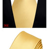 A close-up of a gold silk necktie tied in a four-in-hand knot against a black shirt collar.