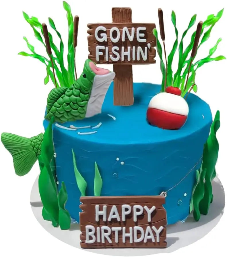 A blue fishing theme party cake decorated with wooden signs and green foliage.