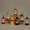 A collection of vintage-style battery-powered desk lamps in various sizes and finishes on a white surface.