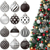 A collection of black and white polka dot winter ball Christmas ornaments hanging on a green fir tree.